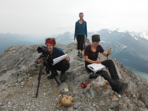 [Left to right] Kristen Walsh, Mandy Arnaud and Nicole Goodman lining up historic photos and preparing field notes